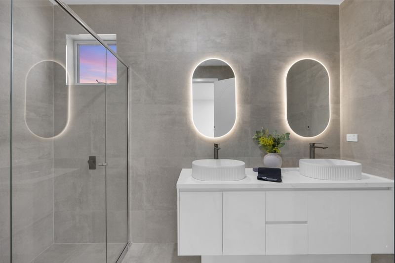 Ensuite with double vanity, fluted basins and LED-lit mirrors
