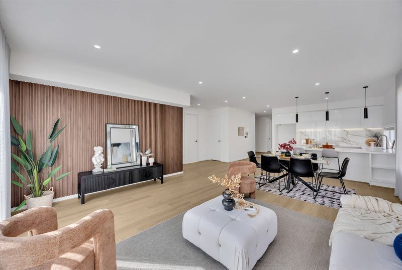 Living area with timber feature wall, opening to dining and kitchen