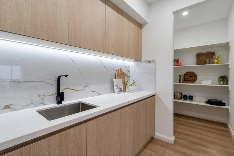 Butler's pantry with stone benchtop, LED strip lighting and walk-in pantry
